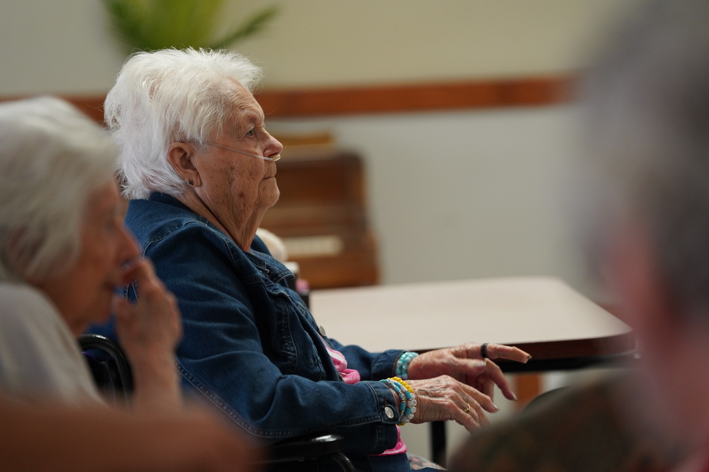 Nursing home resident listening to the band play