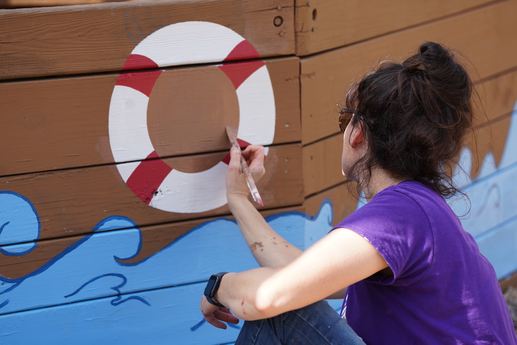 CHS art teacher painting at Acme Brick Park