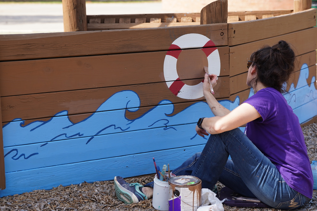 CHS art teacher painting at Acme Brick Park