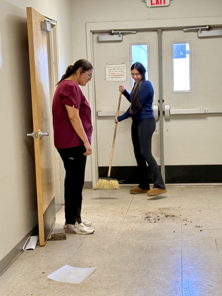 Senior Capstone students sweeping the floor at the Frisco Center.