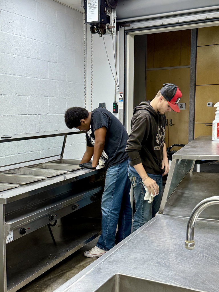 Senior Capstone students cleaning the kitchen at the Frisco Center.