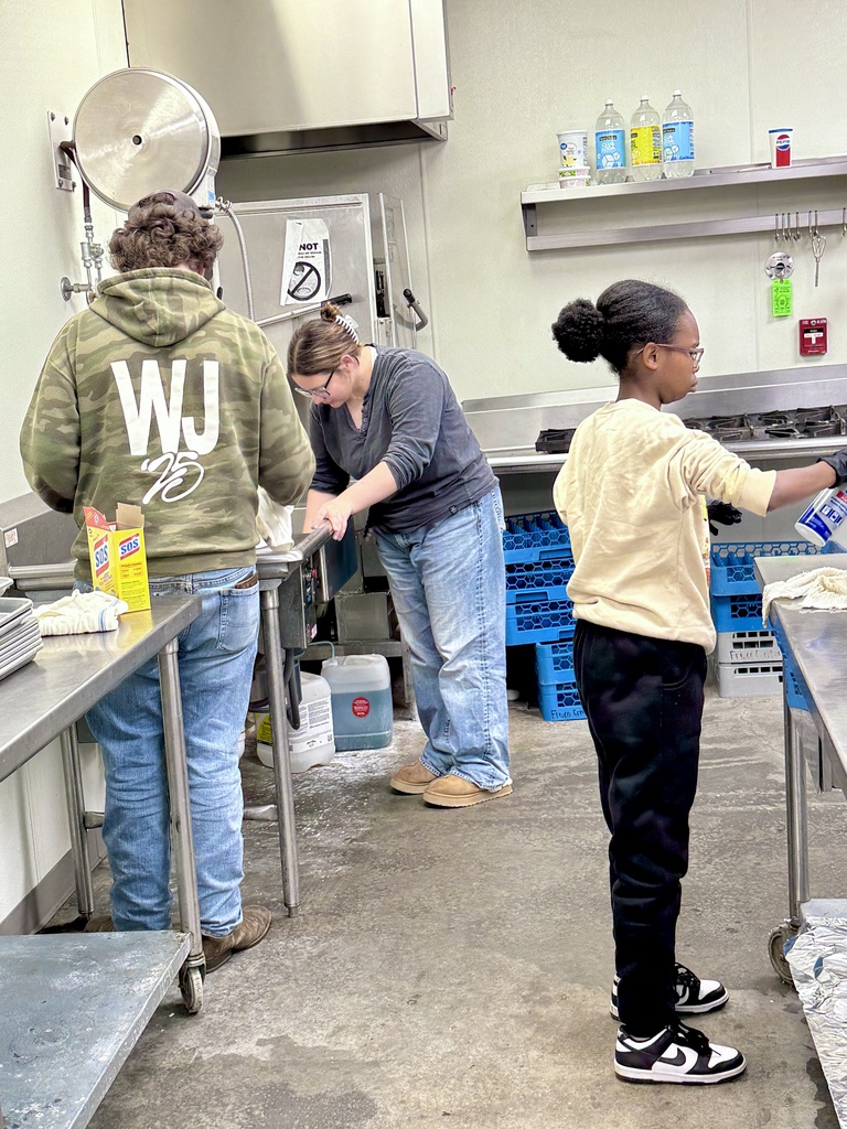 Senior Capstone students cleaning the kitchen at the Frisco Center.