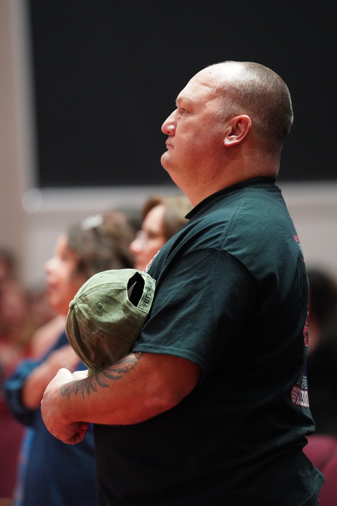 Veteran with hat over his heart
