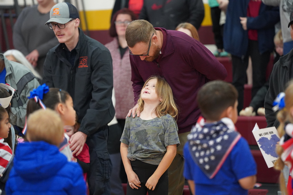 Coach Deatherage and his daughter at the Veterans assembly