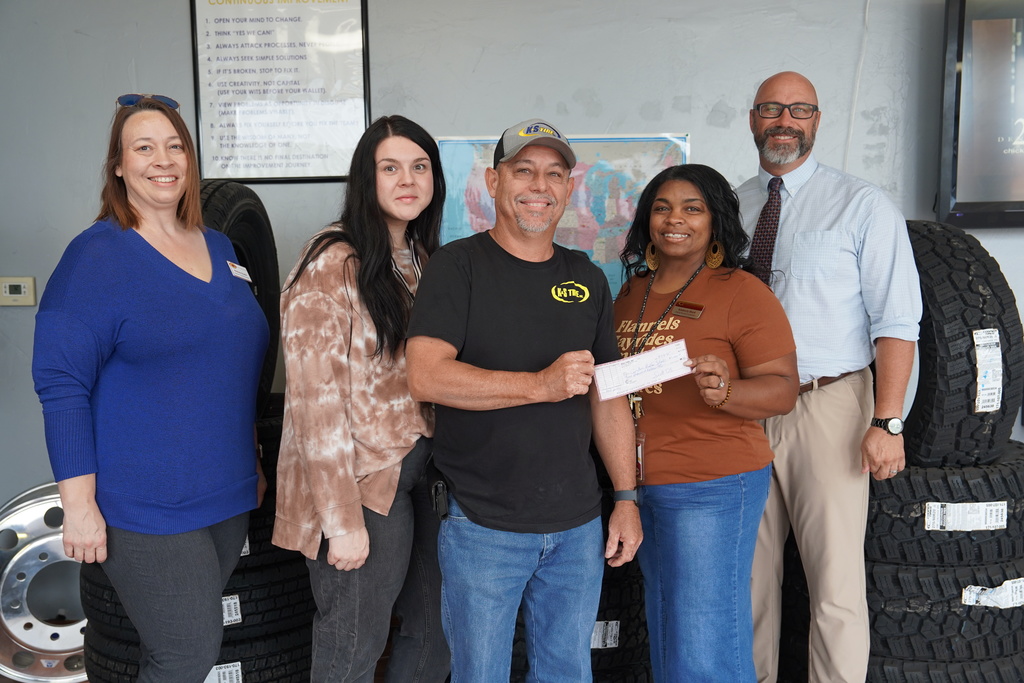 CPS staff with K&S Tire receiving a check for $5,000.