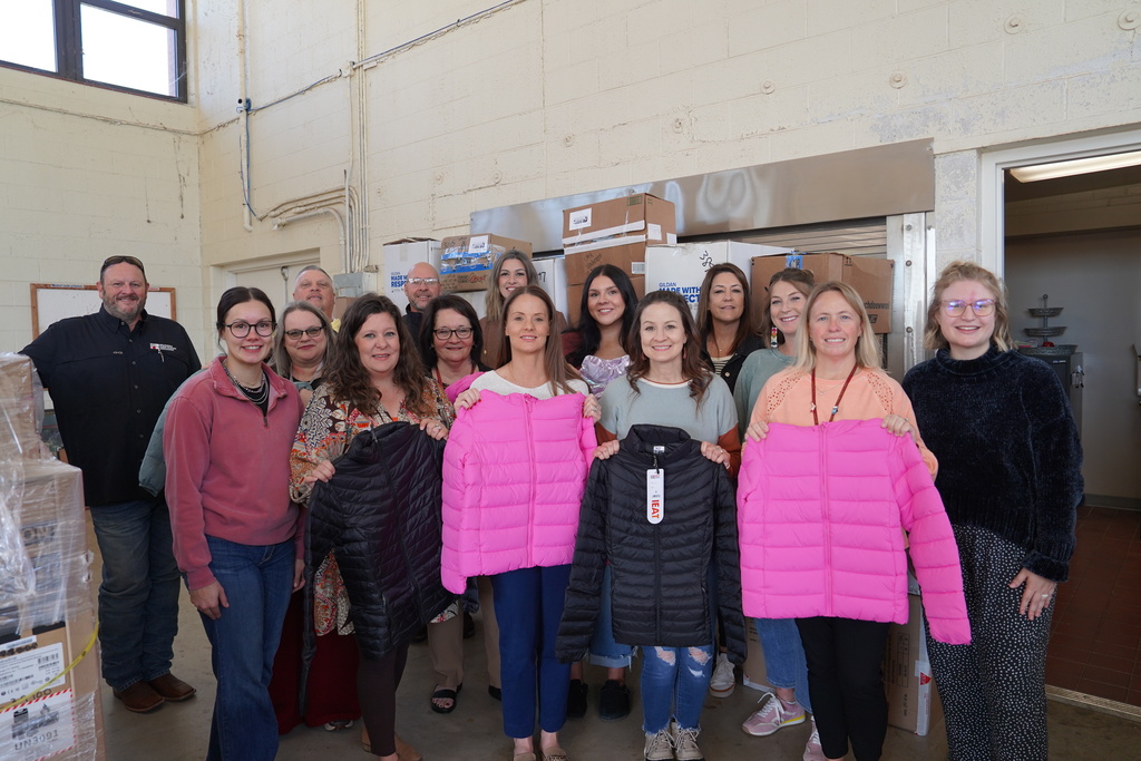 CPS staff and Farm Bureau employees with coat donation from Farm Bureau
