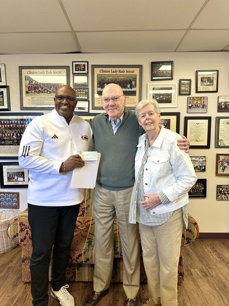 Coach J and the Blakenships presenting a check in memory of Harold Miskel.