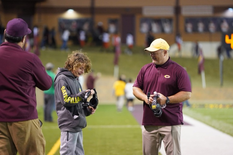 Coach Ray and his son on the sidelines