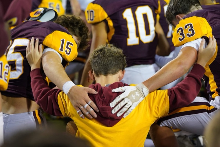 Football team huddle after the game 