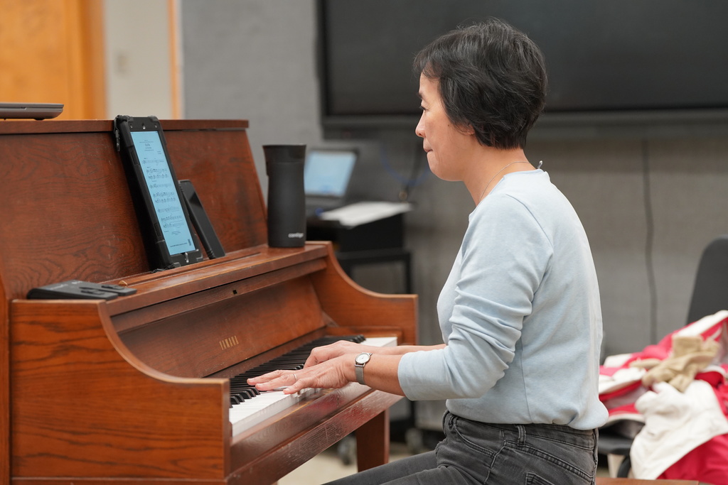 Side view of Dr. Lee playing the piano