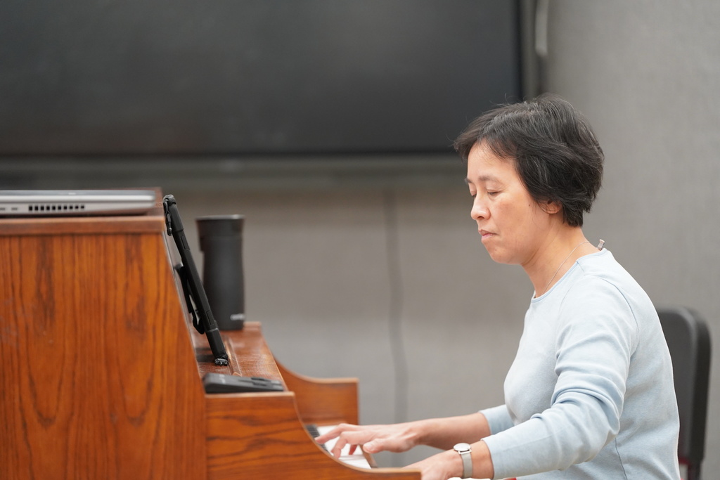Dr. Lee playing the piano for the CHS choir