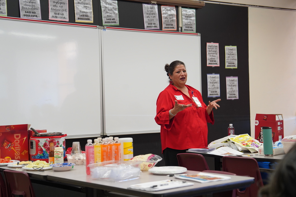 Ms. Fletcher talking to students in classroom