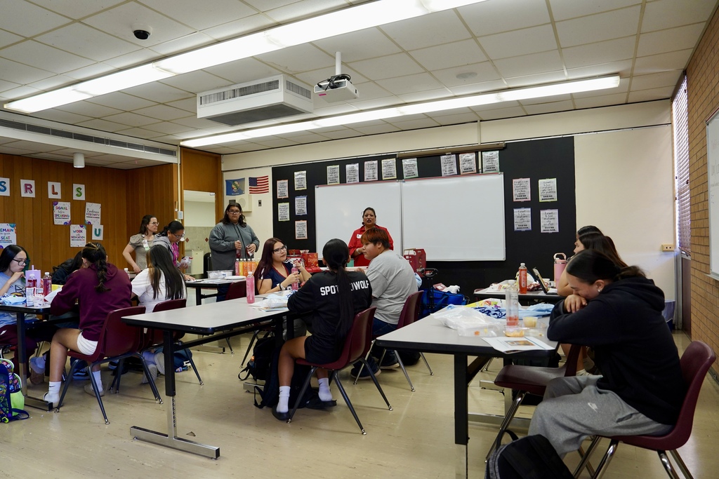 Students listening to speaker in classroom