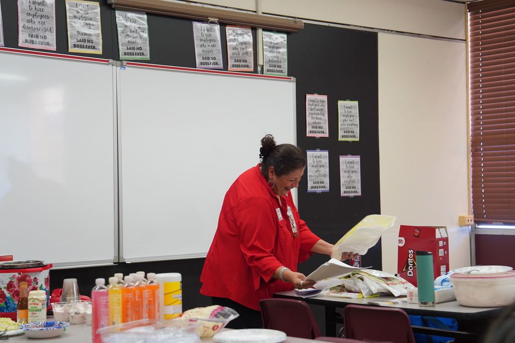 Ms. Fletcher smiling while looking for info