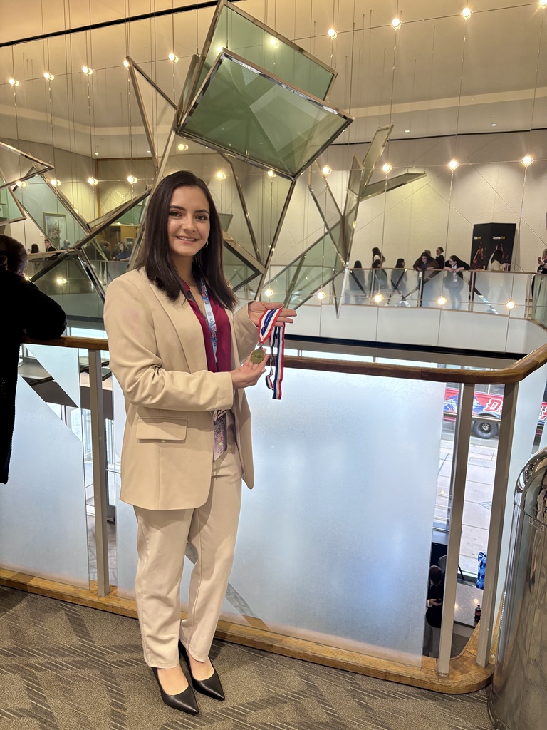 student holding medal from state bpa conference