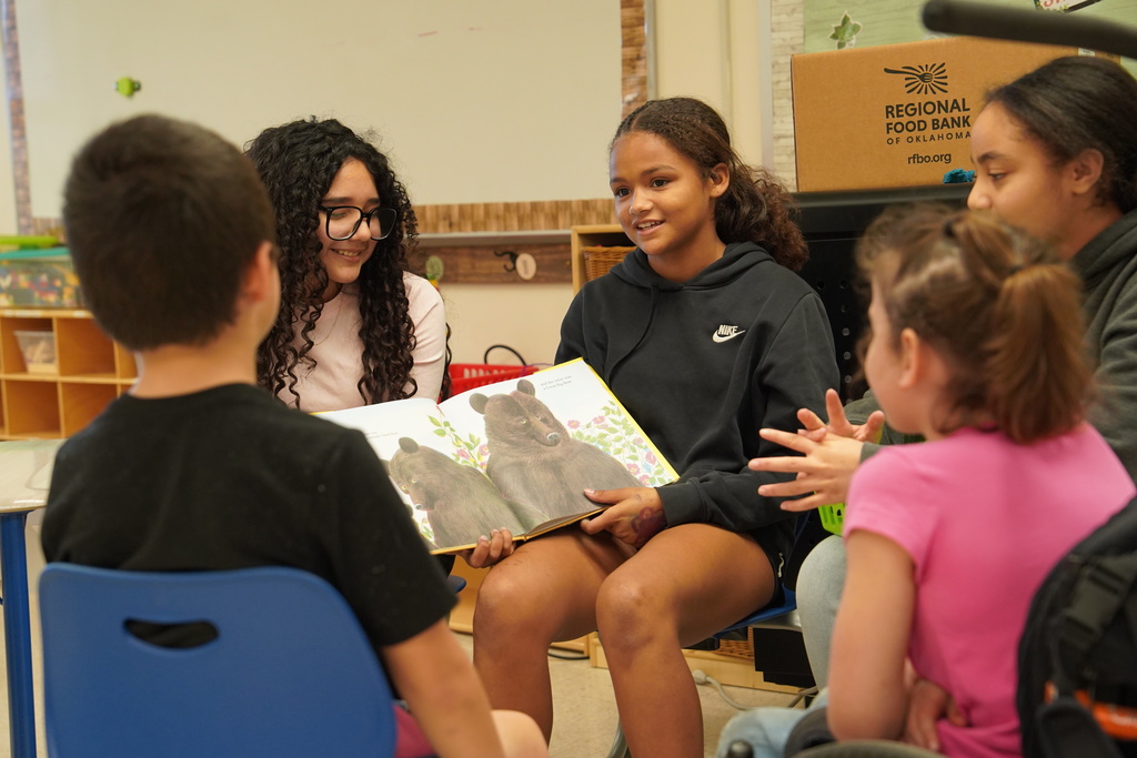 Group of students reading a book
