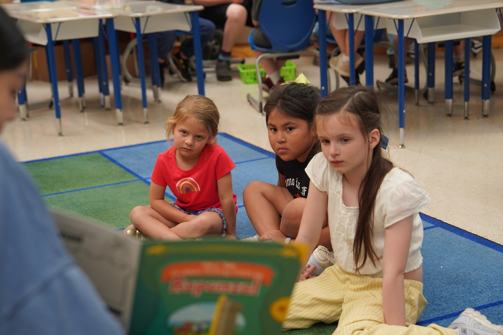 Nance students looking a book being read to them