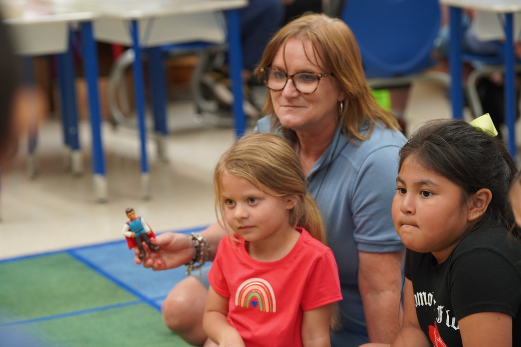 Teacher sitting with Nance students