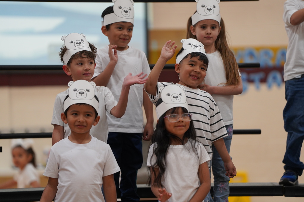 Students waving at family before the Kindergarten program