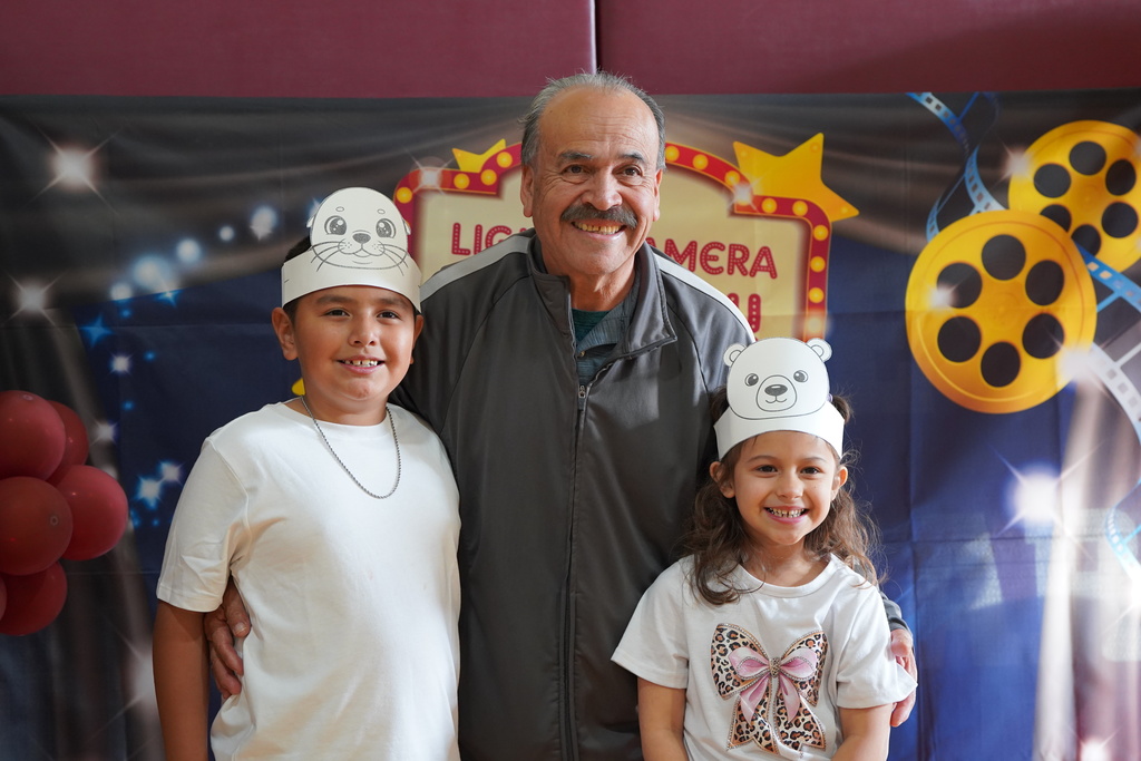 Family posing for pictures after the Kindergarten program