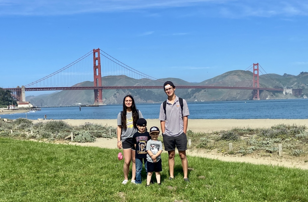Family standing in front of the Golden Gate Bridge