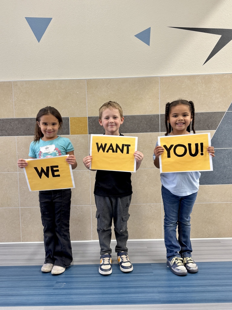 Students holding signs that say We Want You.