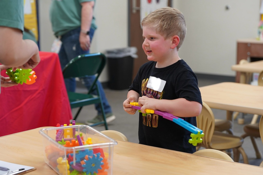 Student playing with gears