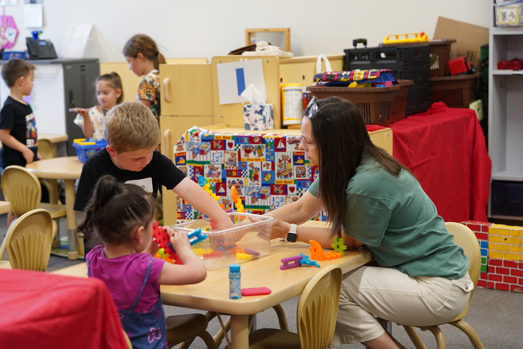 Teacher at table with students