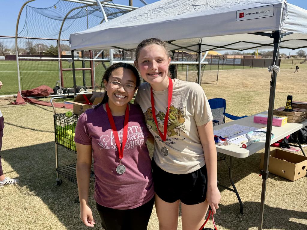 Students standing with tennis medals around their neck