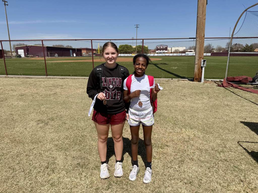 Tennis players standing in front of fence 