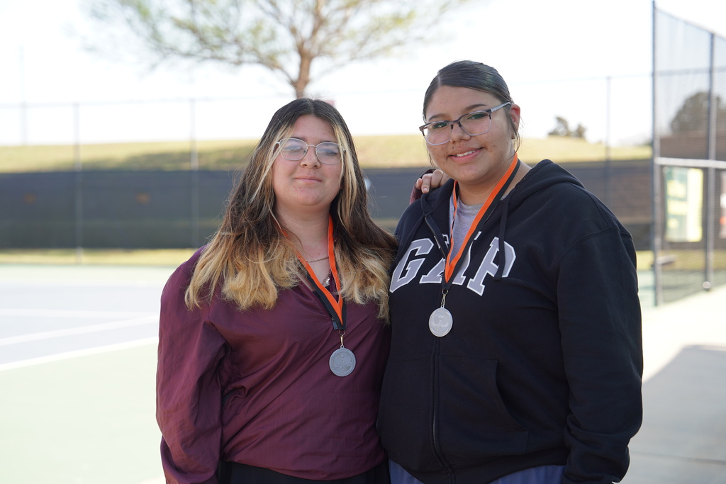Tennis players wearing 2nd place medals