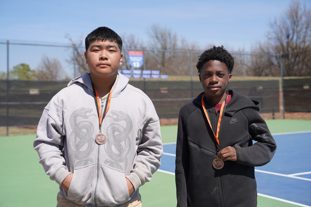 Doubles tennis players wearing 5th place medals