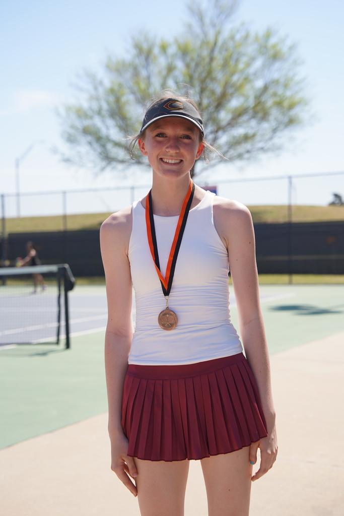 Tennis player wearing 5th place medal