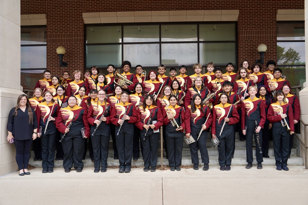 CHS Wind Ensemble holding instruments on steps