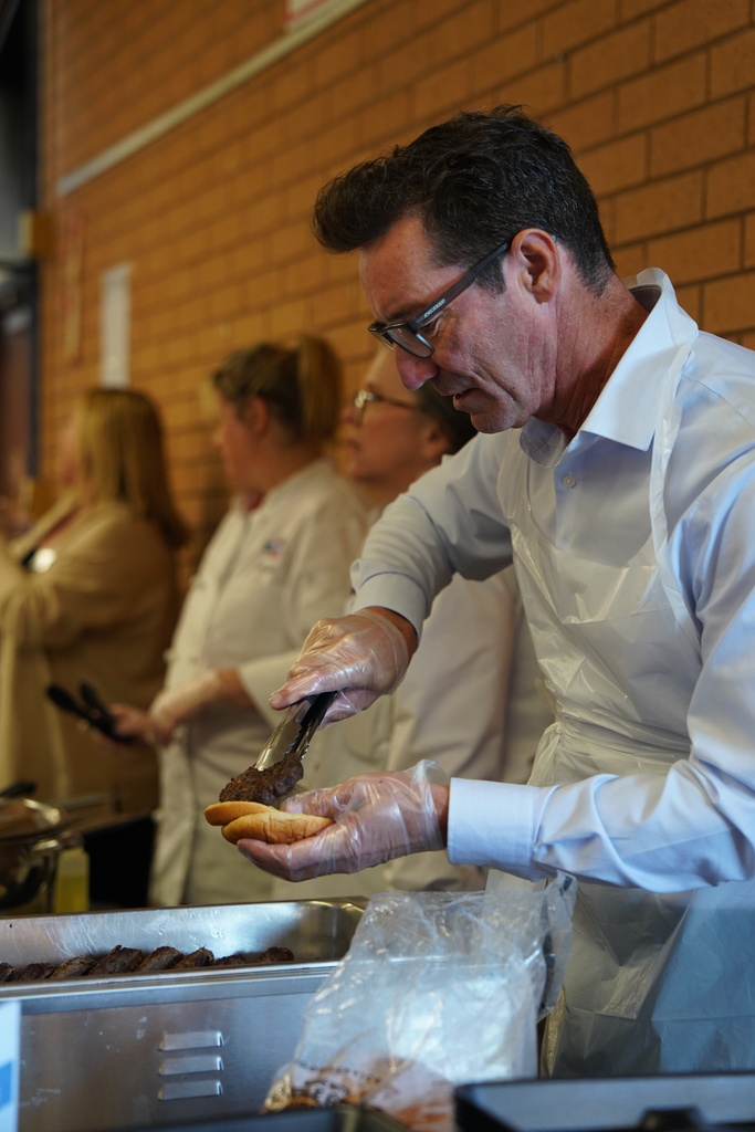Worker putting hamburger together