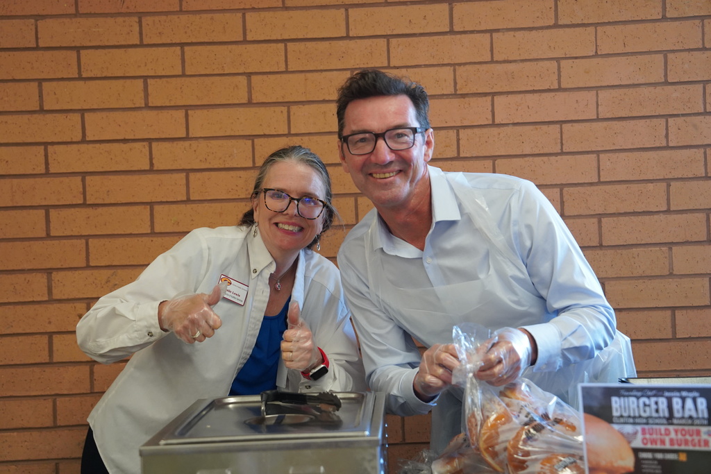 Two cafeteria workers smiling