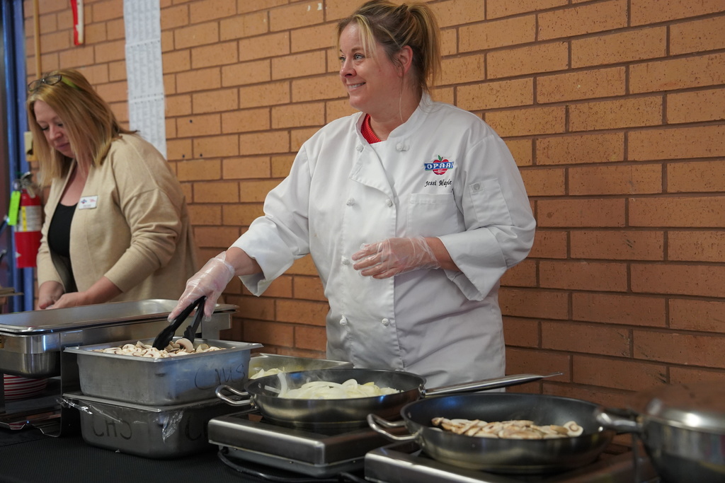 Chef cooking onions and mushrooms