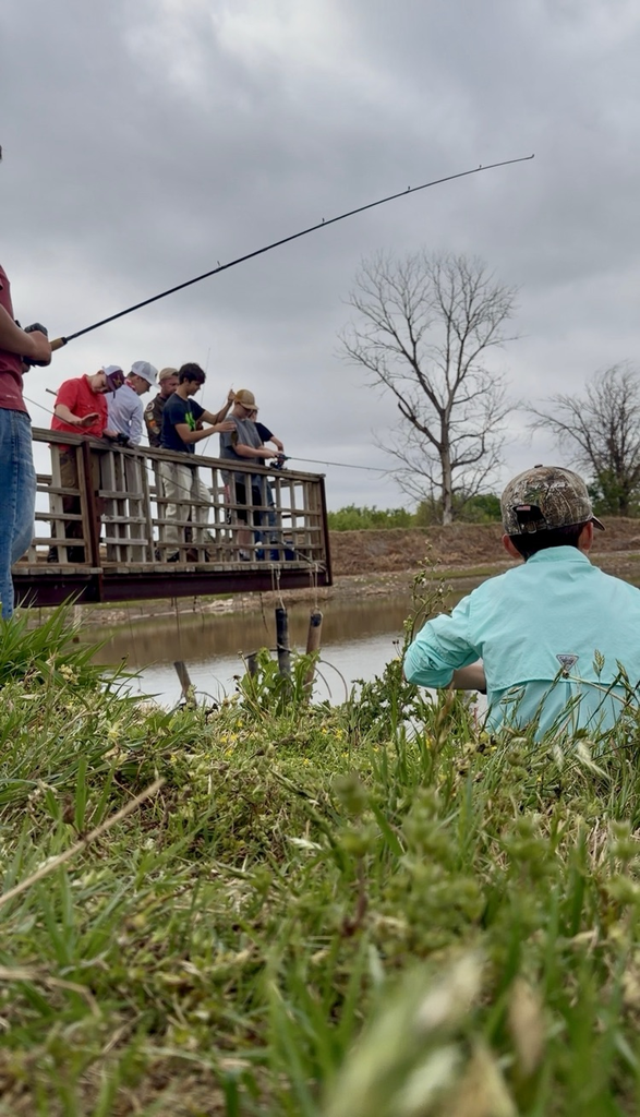 students fishing on dock
