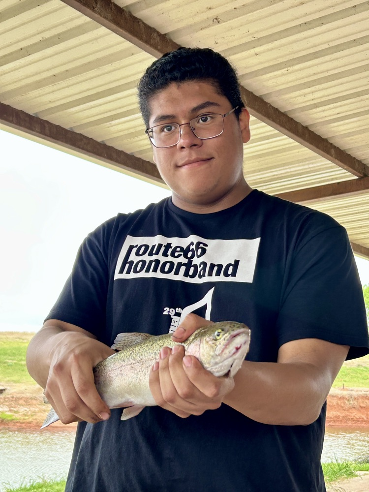 CHS student holding the fish he caught 