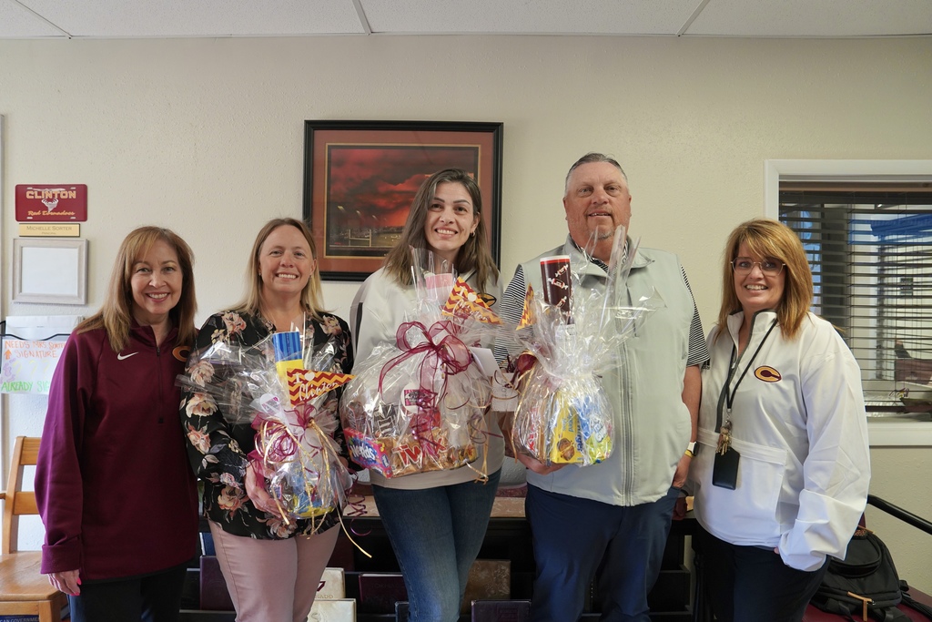 CHS Principals holding gift baskets with admin assistants standing beside them
