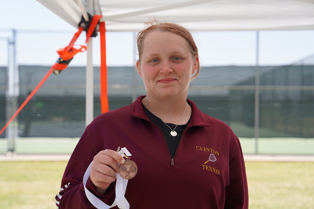 Lady Reds Tennis player holding medal