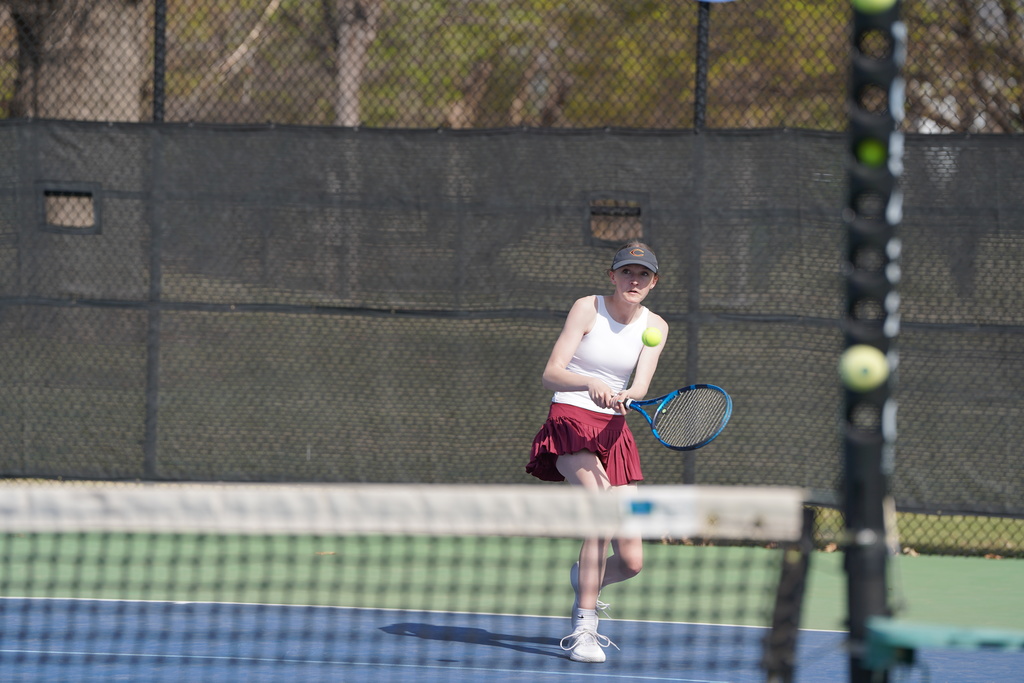 Lady Reds Tennis player going for the shot