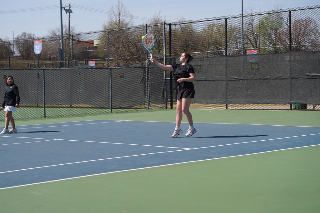 Lady Reds Tennis player returns the ball