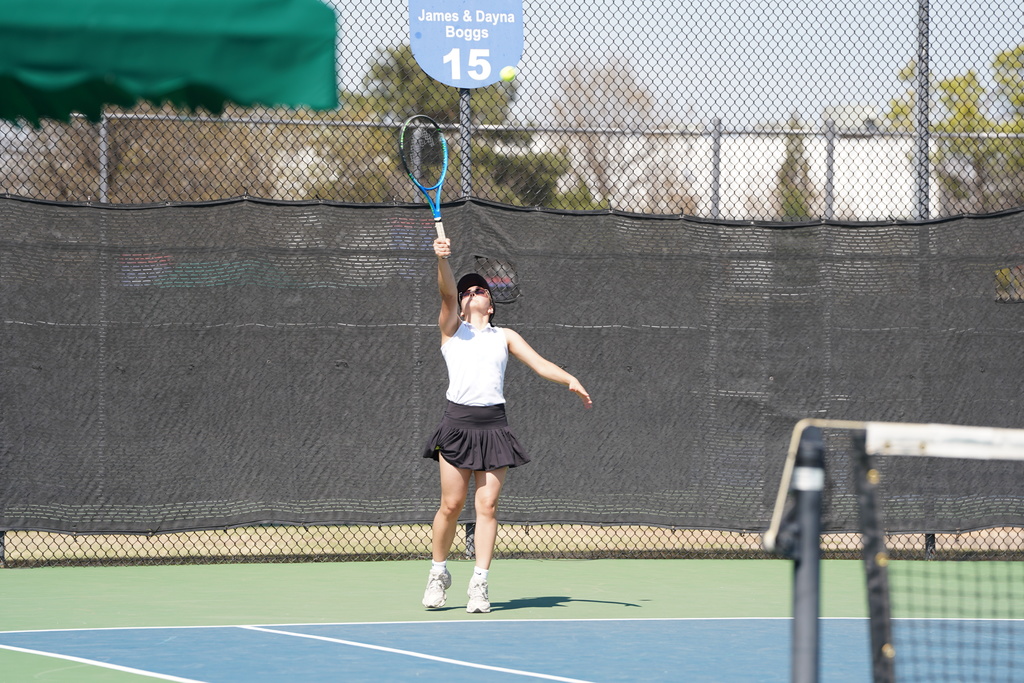 Serve by a Lady Reds Tennis player