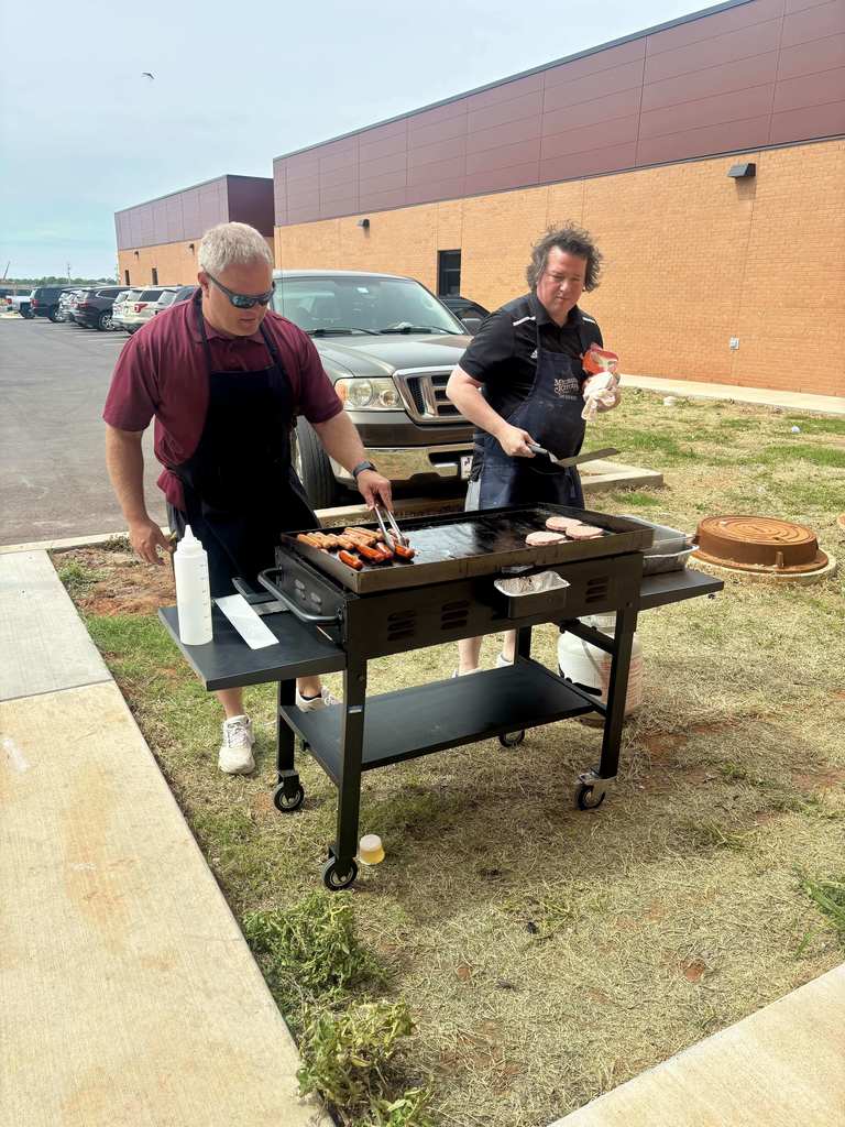 Mr. Ray and Mr. Wheeler grilling hot dogs