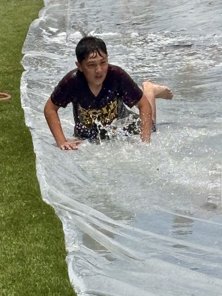 Student sliding at CMS Champions Party