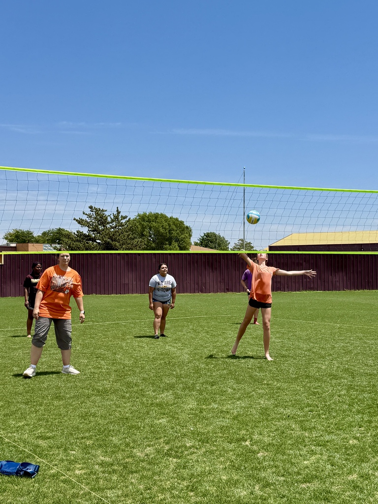 Student serving the volleyball at CMS Champions Party