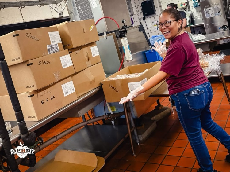 Cafeteria worker loading boxes of food