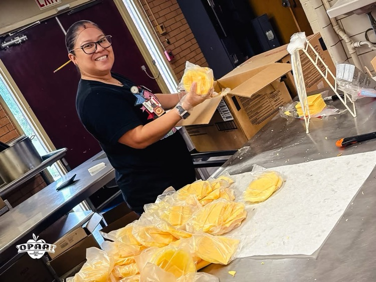 Cafeteria worker wrapping cheese for lunches
