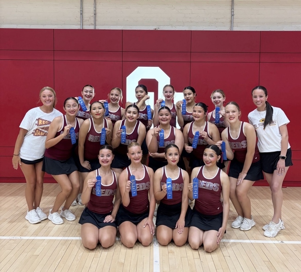 Clinton High School Pom Team holding superior ribbons from camp